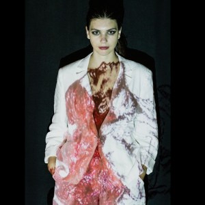 Maura Dudas with her own art projected on her